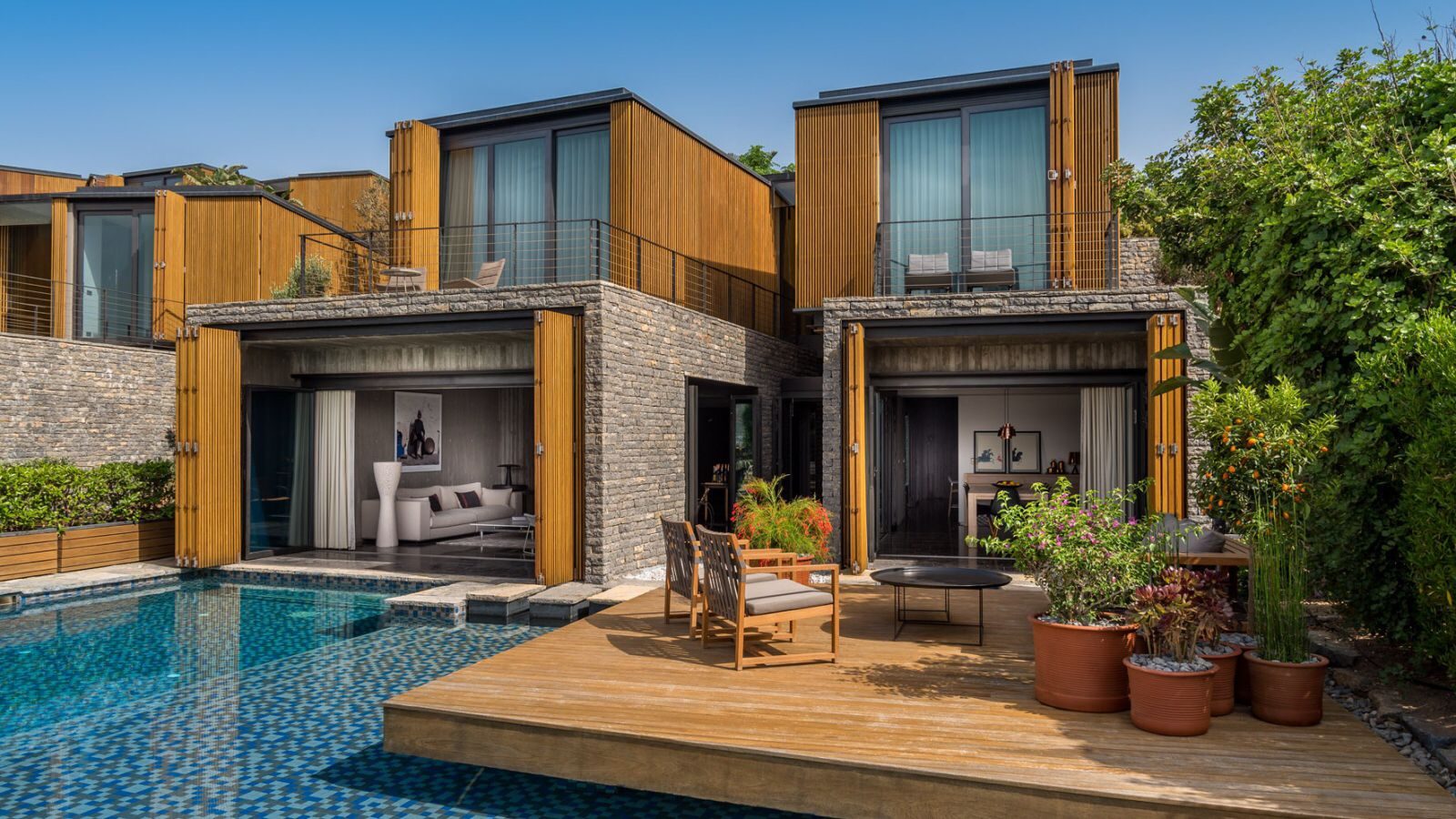 Villa with composite and stone cladding, pool and decking terrace