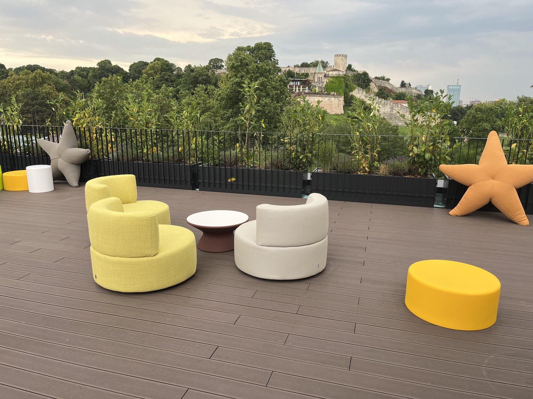 Rooftop terrace finished with composite decking, colourful modern seating group